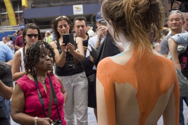 Model Gianna James, right, stripped to her birthday suit to be painted by artist Andy Golub in the heart of Times Square on July 9, 2013.
