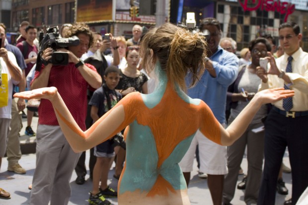 Model Gianna James, right, stripped to her birthday suit to be painted by artist Andy Golub in the heart of Times Square on July 9, 2013.